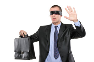 Confused blindfold businessman with briefcase