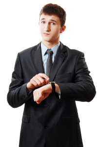 man pointing at his watch